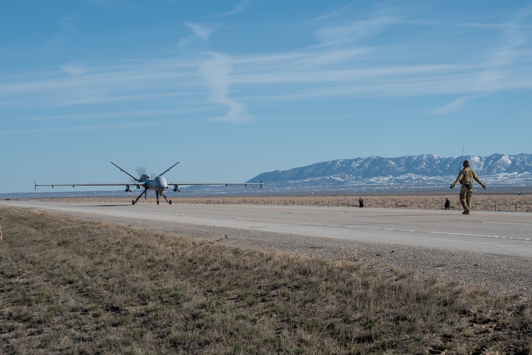 An MQ-9 Reaper lands on Highway 287 in Wyoming during Exercise Agile Chariot on April 30, 2023, honing capabilities linked to Agile Combat Employment. Instead of relying on large, fixed bases and infrastructure, ACE employs smaller, more dispersed locations and teams to rapidly move aircraft, pilots and other personnel as needed. Under ACE, millions of miles of public roads can serve as functional runways with Forward Arming and Refueling Points when necessary. (U.S. Air National Guard photo by Master Sgt. Phil Speck)