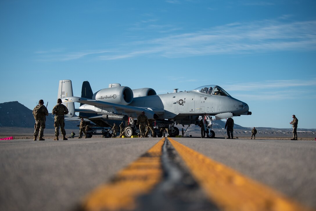 Airmen with the 127th Fighter Wing conduct an Integrated Combat Turn weapons reload on one of their A-10 Thunderbolt IIs on Highway 287 in Wyoming during Exercise Agile Chariot, April 30, 2023, honing capabilities linked to Agile Combat Employment. Instead of relying on large, fixed bases and infrastructure, ACE employs smaller, more dispersed locations and teams to rapidly move aircraft, pilots and other personnel as needed. Under ACE, millions of miles of public roads can serve as functional runways with Forward Arming and Refueling Points when necessary. (U.S. Air National Guard photo by Master Sgt. Phil Speck)