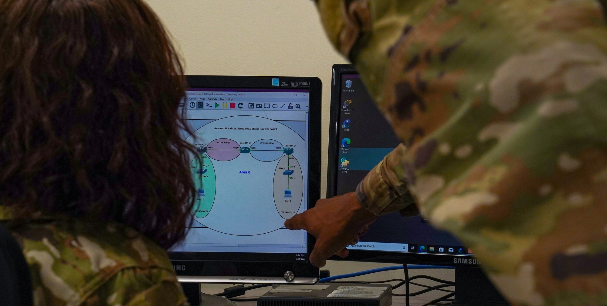 U.S. Air Force Tech. Sgt. Antoine Brown, 338th Training Squadron network systems operations course instructor, instructs U.S. Space Force Spc. 3 Thalia Merced, 338th TRS student, in Dolan Hall at Keesler Air Force Base, Mississippi, April 24, 2023.
