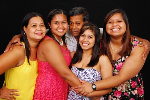  U.S. Space Force Master Sgt. Ana Afonso poses with her family. Afonso says she feels most connected to her Filipino roots by celebrating with food and family.