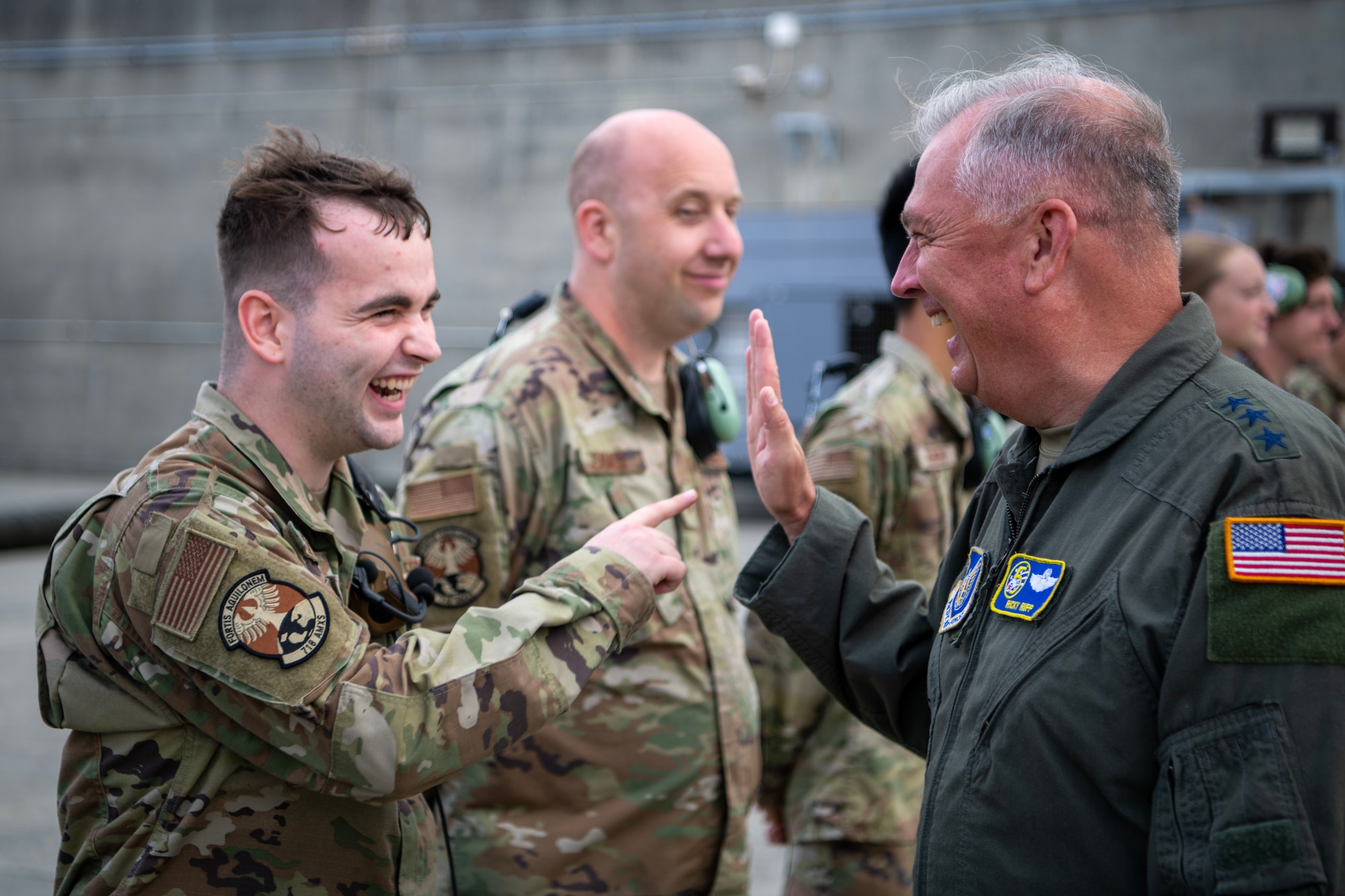General Rupp laughing with Airmen from the 718th Aircraft Maintenance Squadron.