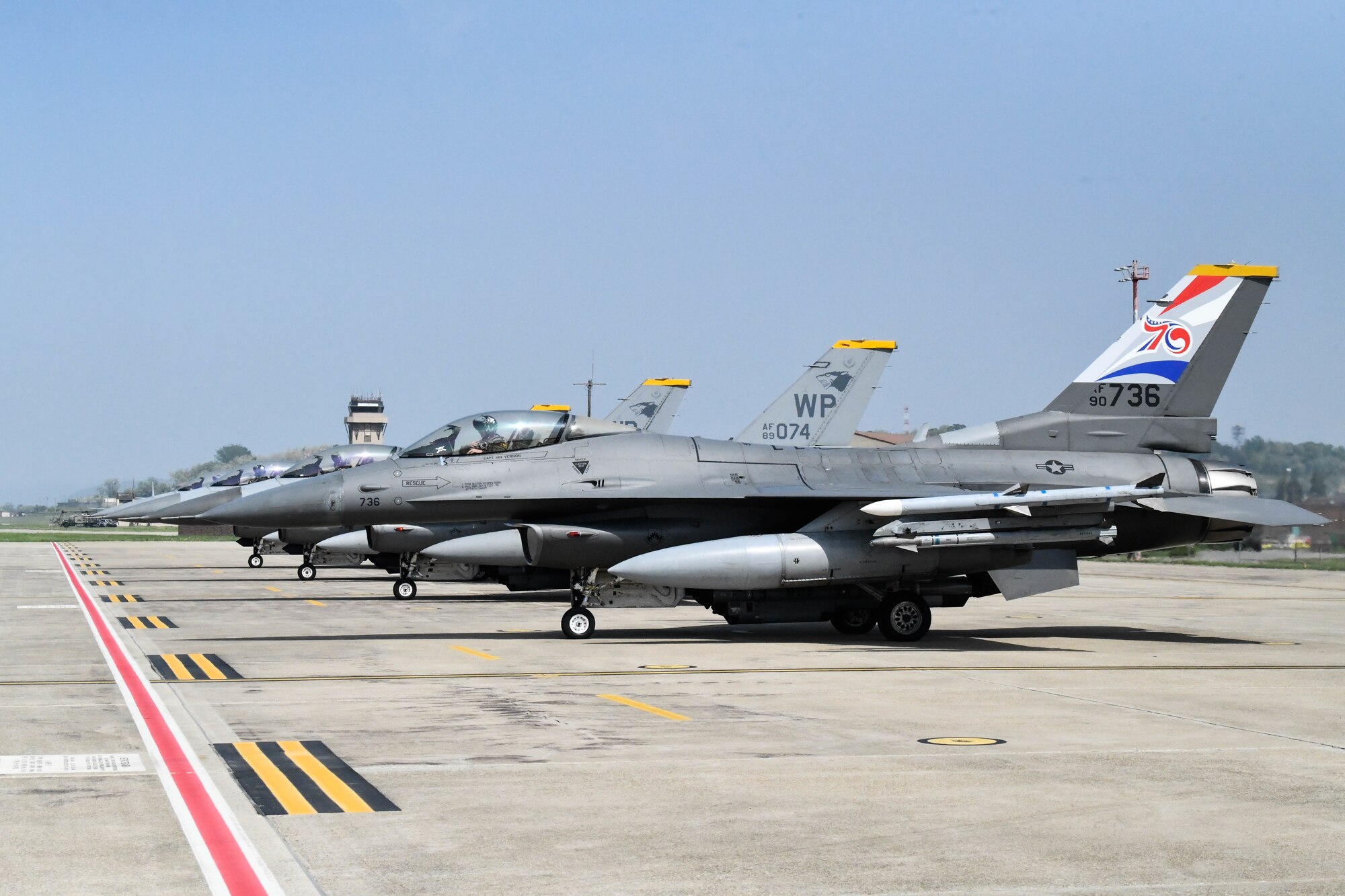 F-16 Fighting Falcons assigned to the 8th Fighter Wing, Kunsan Air Base, Republic of Korea, line up before taxiing to the runway, one with a U.S.-ROK Alliance 70th Anniversary tail flash, at Osan AB, ROK, May 7, 2023. Three aircraft from the 8FW and four from the ROK Air Force 38th Fighter Group have been fitted with the commemorative decals. (U.S. Air Force photo by 1st Lt. Cameron Silver)
