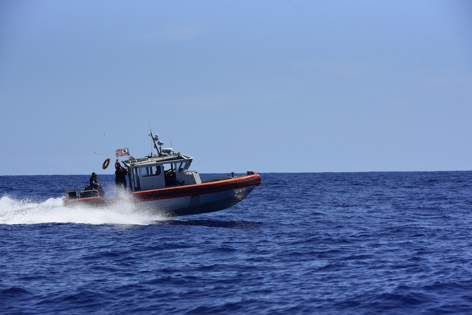 A 35-foot Long-Range Interceptor-II (LRI) cutter boat crew trains for a man- overboard scenario in the vicinity of U.S. Coast Guard Cutter Stratton (752), west of Hawaii, while deployed on a Western Pacific patrol April 20, 2023. Stratton deployed to the Western Pacific to conduct planned, collaborative engagements with ally and partner nations intent on preserving a rules-based order in the Indo-Pacific maritime domain. (U.S. Coast Guard photo by Petty Officer 2nd Class Michael Clark)