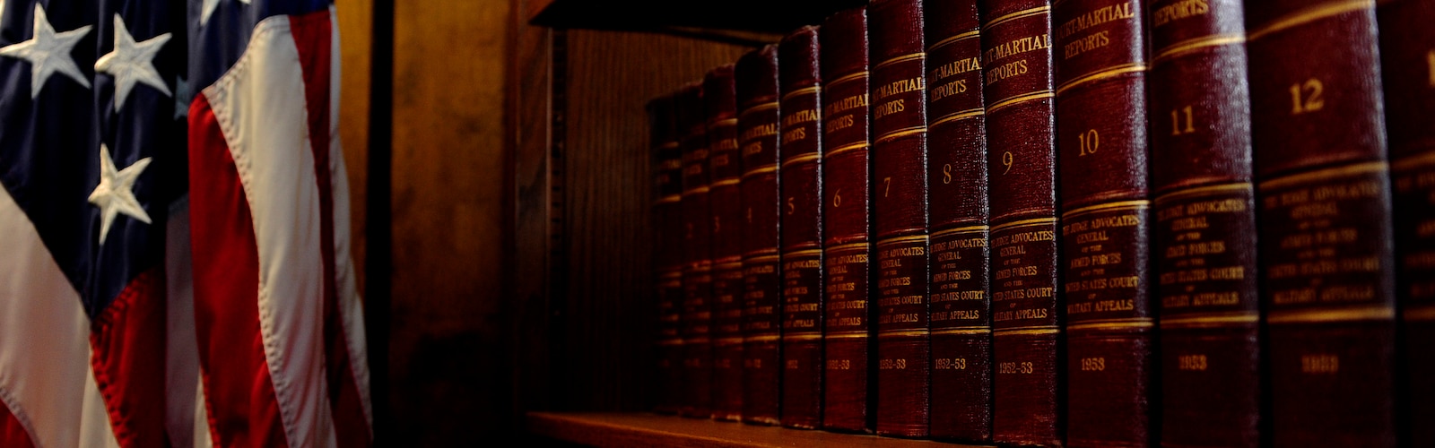 Volumes of “Court-Martial Reports” line the bookshelf located in the courtroom. These books are essential to understanding military law and court-martial cases, and also document and archive vital court-martial cases often cited as references during trials. (U.S. Air Force photo by Airman 1st Class Daniel Blackwell/Released)