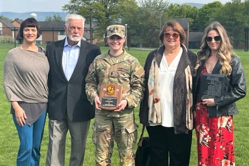 Second Lt. Lea Lenker, center, poses for a photo with members of Capt. Brian Faunce's family after Lenker received the Capt. Brian Faunce Memorial Scholarship Award April 27, 2023, at Penn State University. The award is presented annually to a graduating Penn State Army ROTC student who best demonstrates the spirit, leadership and courage of Faunce. (Courtesy photo)