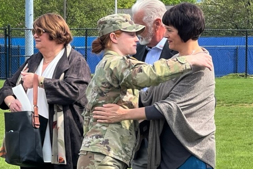 Second Lt. Lea Lenker hugs a member of Capt. Brian Faunce's family after Lenker received the Capt. Brian Faunce Memorial Scholarship Award April 27, 2023, at Penn State University. The award is presented annually to a graduating Penn State Army ROTC student who best demonstrates the spirit, leadership and courage of Faunce. (Courtesy photo)