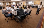 Inho Kim, deputy project superintendent, Code 312, Carrier
Program Office, leads a discussion May 3, 2023, during a Hispanic Employee Resource Organization-sponsored Speed Mentoring event at Olympic Lodge on Naval Base Kitsap-Bangor, Washington. (U.S. Navy photo Wendy Hallmark)