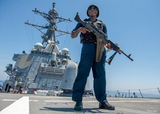 MA1 Julius Earl stands watch aboard USS Paul Hamilton (DDG 60) during a Strait of Hormuz transit.