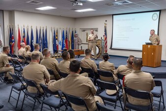 Naval Education and Training Command (NETC) domain fiscal year 2022 Sailor of the Year (SOY) candidates, their command master chiefs, SOY board members and NETC leadership listen to a brief during a visit to the Navy Recruiting Orientation Unit as part of NETC SOY Recognition Week in Pensacola, Florida, May 9, 2023. NETC's mission is to recruit, train and deliver those who serve our nation, taking them from street-to-fleet by forging civilians into highly skilled, operational and combat ready warfighters. (United States Navy photo by Mass Communication Specialist 2nd Class Zachary Melvin)