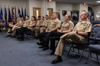 Naval Education and Training Command (NETC) domain fiscal year 2022 Sailor of the Year (SOY) candidates, their command master chiefs, SOY board members and NETC leadership listen to a brief during a visit to the Navy Recruiting Orientation Unit as part of NETC SOY Recognition Week in Pensacola, Florida, May 9, 2023. NETC's mission is to recruit, train and deliver those who serve our nation, taking them from street-to-fleet by forging civilians into highly skilled, operational and combat ready warfighters. (United States Navy photo by Mass Communication Specialist 2nd Class Zachary Melvin)