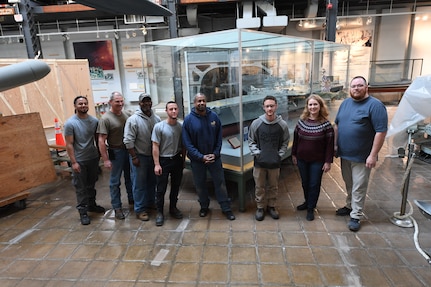 Naval Surface Warfare Center, Carderock Division’s model moving team poses in front of the USS Forrestal (CVA 59) model at its new home in the National Museum of the U.S. Navy at the Washington Navy Yard in Washington, D.C., on April 10. From left are: Marcus Gutierrez, Jimmy Schulze (Code 10212), Terry Goodwin, David Patton, Lewis D’Almeida, Brandon Patton, Jennifer Marland (Code 102B) and Brian Potter (Code 102B). (U.S. Navy photo by Neubar Kamalian)