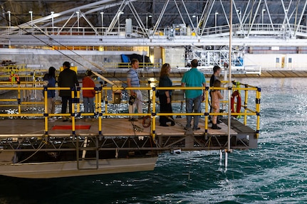 Naval Surface Warfare Center, Carderock Division employees and their children watch as waves are created in the Maneuvering and Seakeeping Basin in West Bethesda, Md., on April 27. (U.S. Navy photo by Kristin Behrle)