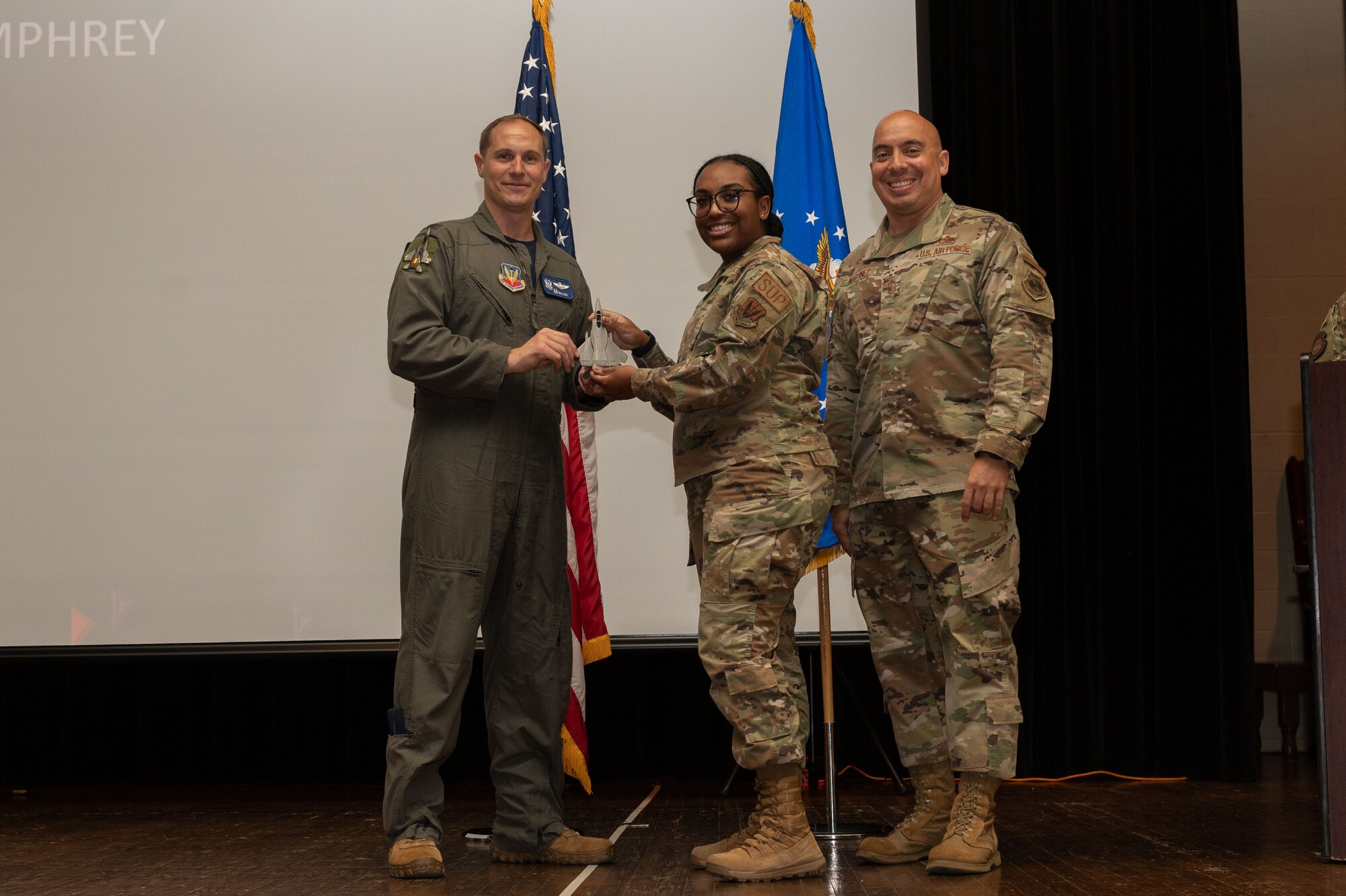 Staff Sgt. Alexandria Humphrey, center, 4th Logistics Readiness Squadron NCO in charge inspection, receives the Volunteer of the Quarter award from Col. Lucas Teel, left, 4th Fighter Wing commander, and Chief Master Sgt. Peter Martinez, 4th FW command chief, during the 4th FW 1st Quarter Awards Ceremony at Seymour Johnson Air Force Base, North Carolina, May 5, 2023. Quarterly awards were awarded to Airmen and civilians in 12 different categories, to recognize the recipients exceptional work. (U.S. Air Force photo by Airman 1st Class Rebecca Sirimarco-Lang)