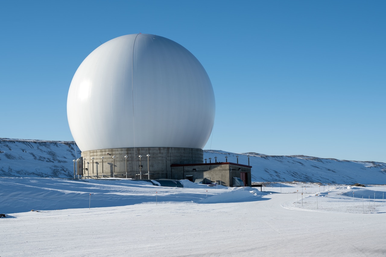 A radar dome sits outside in a snowy environment.