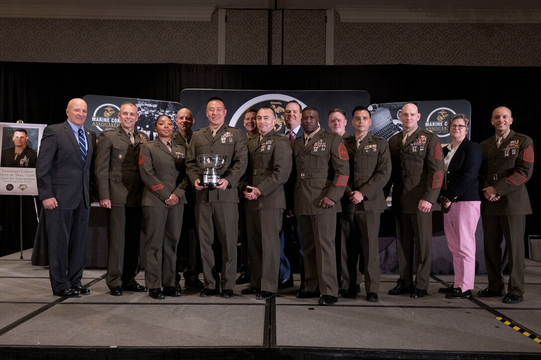 U.S. Marines with 3rd Intelligence Battalion pose for a photo with senior leadership at the annual Marine Corps Association information awards dinner in Arlington, Virginia, April 20, 2023. 3rd Intelligence Battalion received the Intelligence Unit of the Year Award for significant contributions to the Marine Corps information occupational fields. 3rd IB belongs to III Marine Expeditionary Force. (U.S. Marine Corps photo by Sgt. Rachaelanne Woodward)