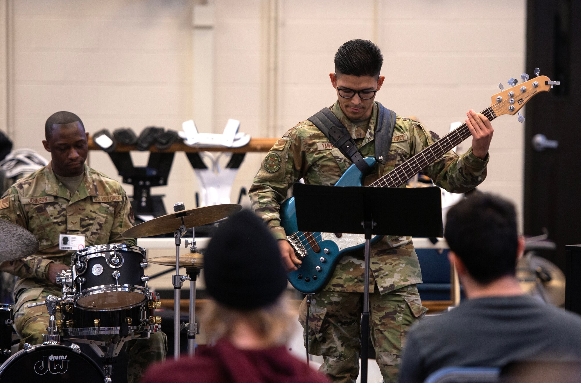 Band members play instruments for high school students