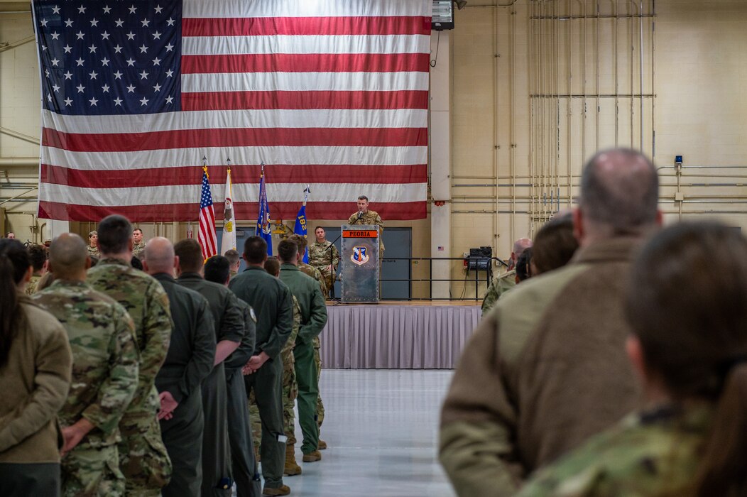 U.S Air Force Col. Rusty Ballard, the commander of the 182nd Airlift Wing, Illinois Air National Guard, addresses the 182nd Airlift Wing in a commander's call at the 182nd Airlift Wing in Peoria, Illinois, April 2, 2023.