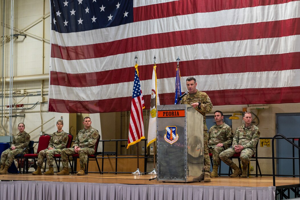 U.S Air Force Col. Rusty Ballard, the commander of the 182nd Airlift Wing, Illinois Air National Guard, addresses the 182nd Airlift Wing in a commander's call at the 182nd Airlift Wing in Peoria, Illinois, April 2, 2023.