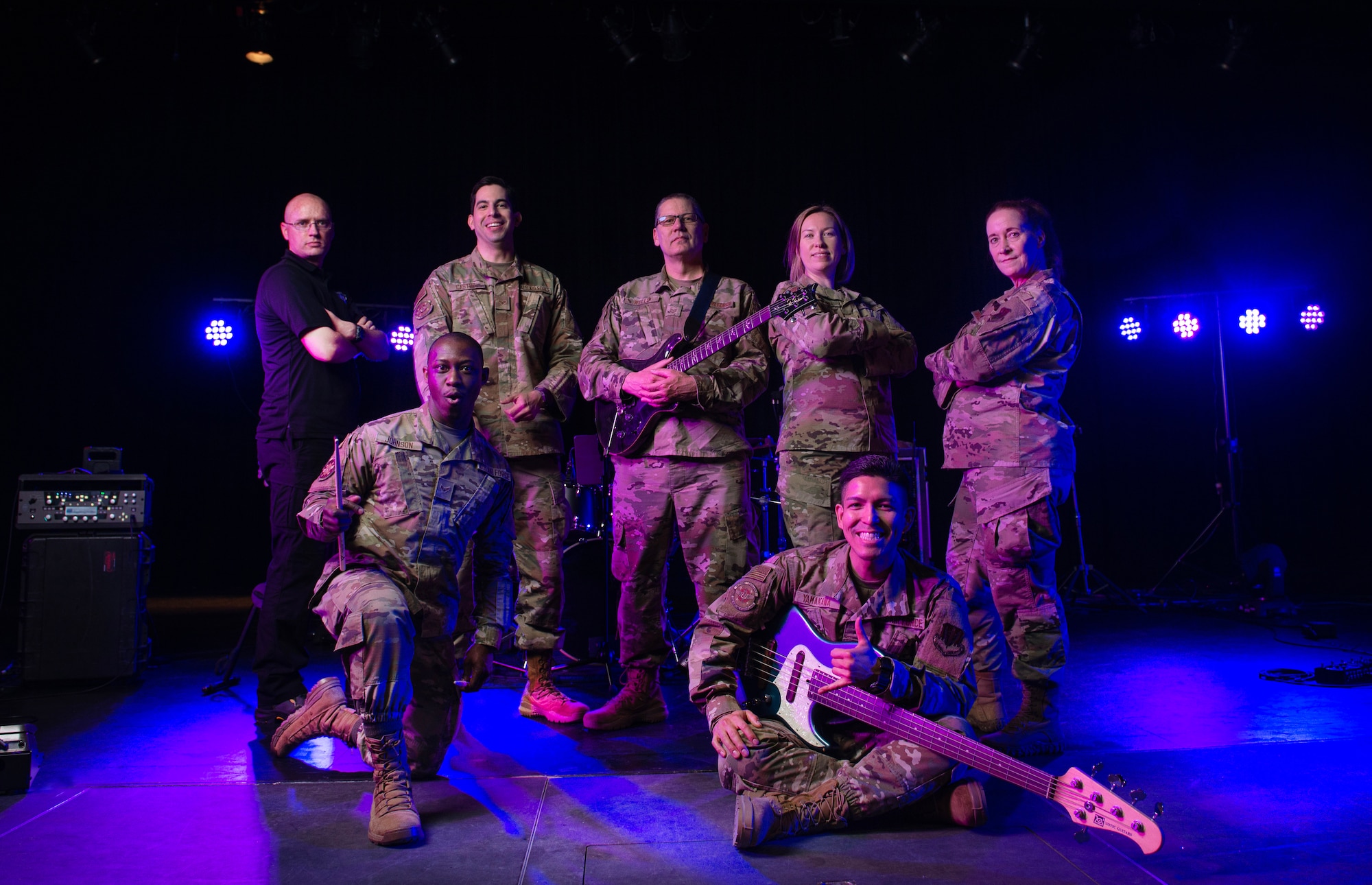 Uniformed Airmen pose for group photo on stage