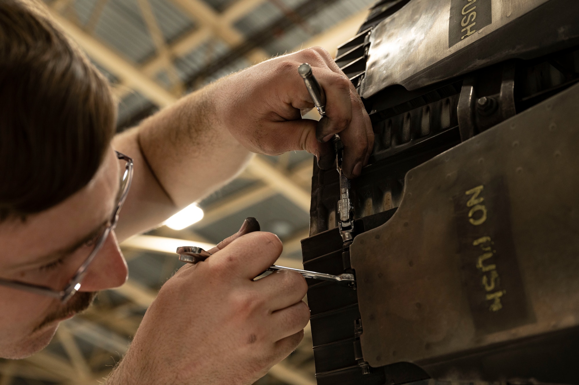 U.S. Air Force Airman 1st Class William Osbourne, 49th Component Maintenance Squadron aerospace propulsion apprentice, conducts maintenance on a Pratt and Whitney F100 engine at Holloman Air Force Base, New Mexico, May 3, 2023. The 49th CMS provides maintenance to all F-16 Vipers on base and ensures that each aircraft is operational for combat effectiveness. (U.S. Air Force photo by Airman 1st Class Isaiah Pedrazzini)