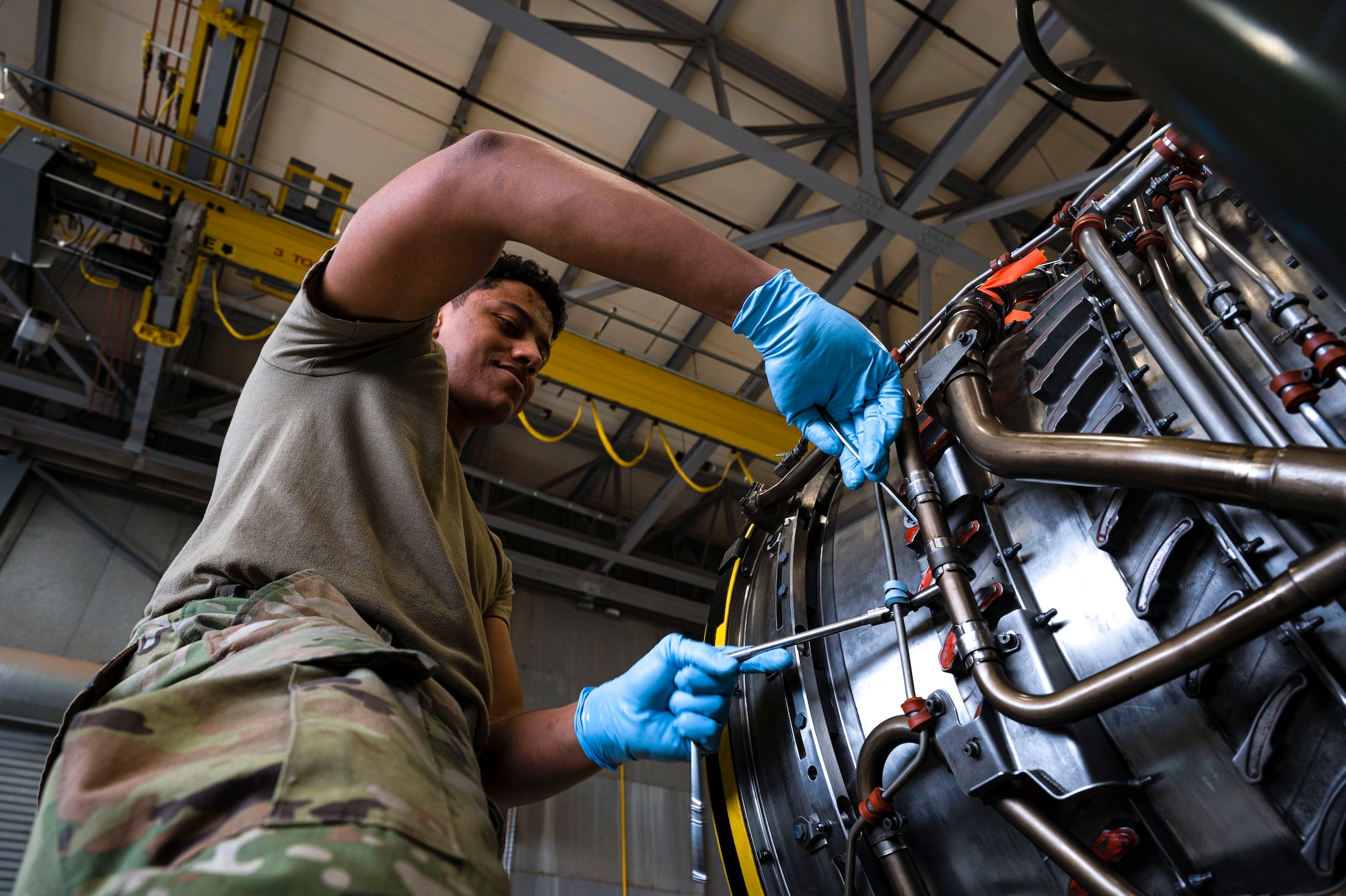 U.S. Air Force Airman 1st Class David Ulerio, 49th Component Maintenance Squadron aerospace propulsion journeyman, conducts routine maintenance on a Pratt and Whitney F100 engine at Holloman Air Force Base, New Mexico, May 3, 2023. The 49th CMS provides maintenance to all F-16 Vipers on base and ensures that each aircraft is operational for combat effectiveness. (U.S. Air Force photo by Airman 1st Class Isaiah Pedrazzini)