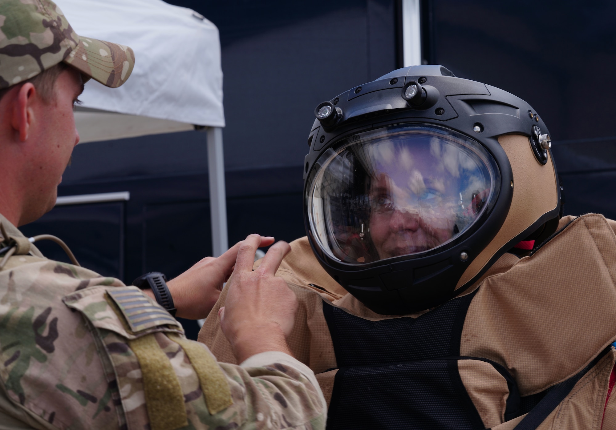 U.S. Air Force Chief Master Sgt. Breanna Oliver, 9th Reconnaissance Wing command chief, don's an Explosive Ordnance Disposal blast suit helmet with the assistance of Staff Sgt. Connor Ely, 9th Civil Engineer Squadron EOD technician, May 6, 2023, at the Chico Regional Airport, Chico, California.