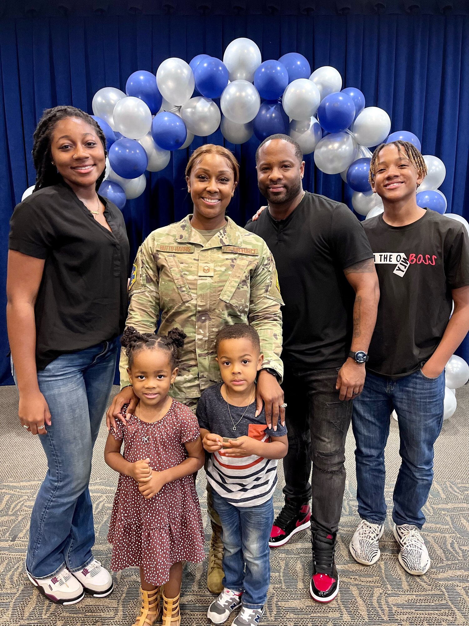 MSgt NeTasha Hutto-Harris stands with her family for a picture after her promotion ceremony. She was so happy they were there.