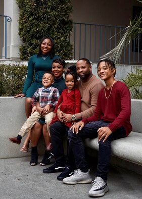 MSgt NeTasha Hutto-Harris and spouse James Harris pose with their children for holiday photos in December 2022.