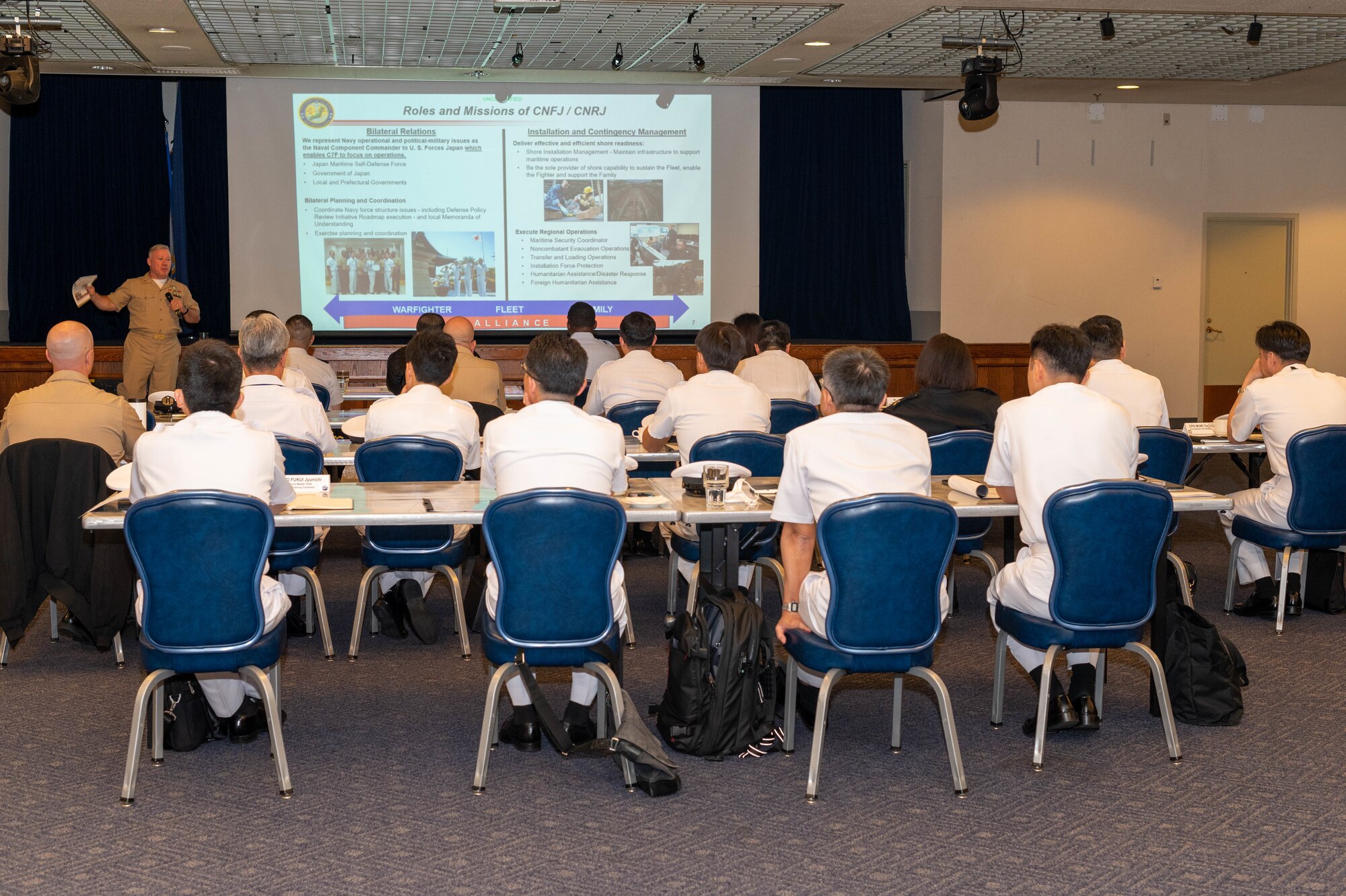 A service member briefs attendees during the 2023 Senior Enlisted Leader Symposium at Yokota Air Base, Japan.