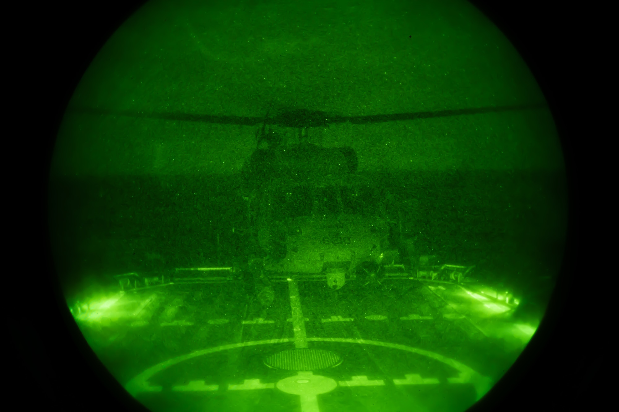 A U.S. Air Force HH-60G Pave Hawk with the 33rd Rescue Squadron lands on the deck of a U.S. Coast Guard vessel during nighttime training off the coast of Okinawa, Japan, May 5, 2023. Pilots from the 33rd RQS trained to land on the deck of a naval ship at night in order to remain ready to act any time. (U.S. Air Force photo by Senior Airman Cedrique Oldaker)
