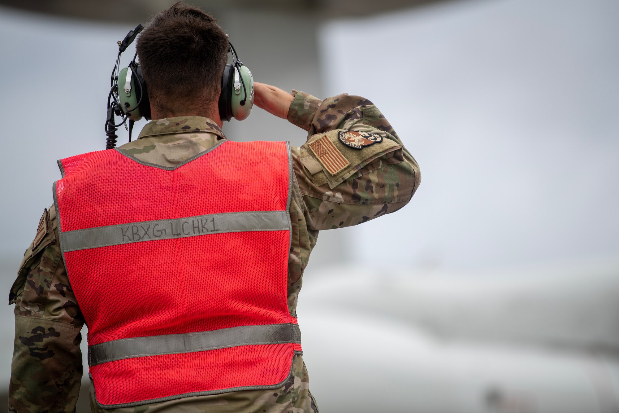 Marshal salutes aircraft as it departs.