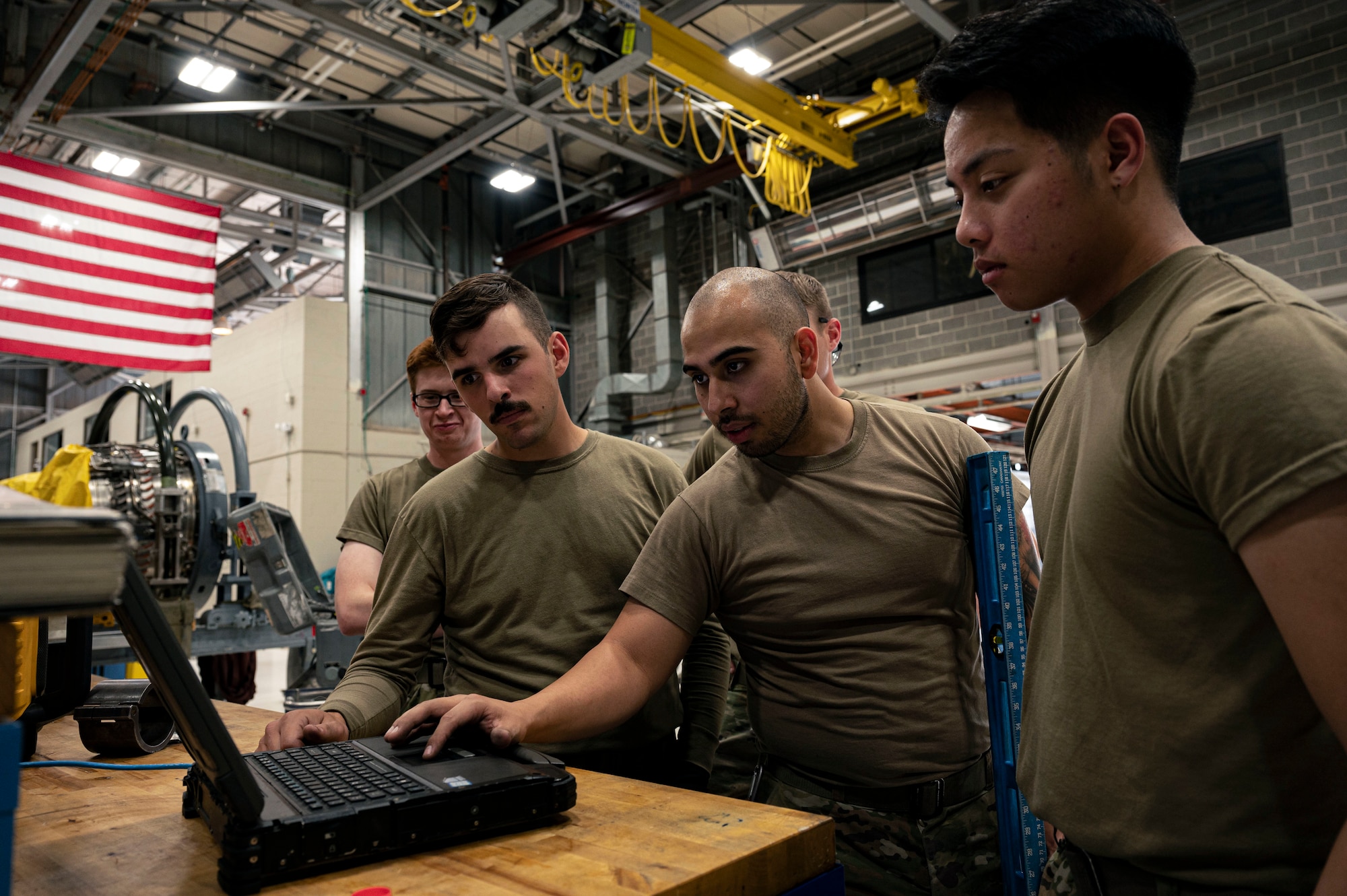 Airmen from the 49th Component Maintenance Squadron propulsion shop discuss the schematics of an engine at Holloman Air Force Base, New Mexico, May 3, 2023. The 49th CMS is composed of more than 190 personnel charged with providing maintenance to the engines that keep Holloman's F-16 Viper pilots in the air. (U.S. Air photo by Airman 1st Class Isaiah Pedrazzini)