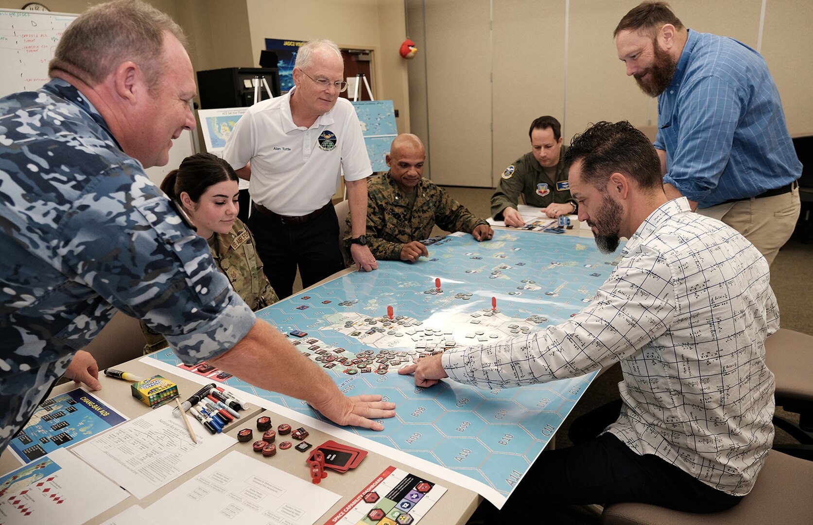 Uniformed US and Royal Australian Air Force members along with civilians test new Kingfish gameboard for Air Operations Center Initial Qualification Training Course