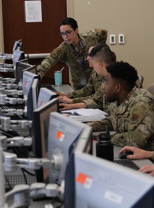  Uniformed US military personnel train at computers during the Air Operations Center Initial Qualification Training Course at Hurlburt Field, Florida.