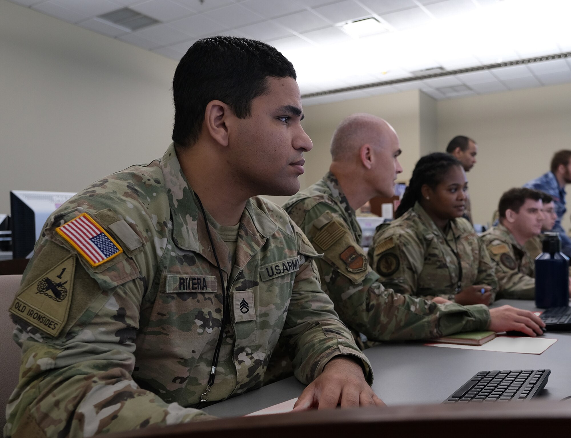 Uniformed US military personnel train at computers during the Air Operations Center Initial Qualification Training Course at Hurlburt Field, Florida.