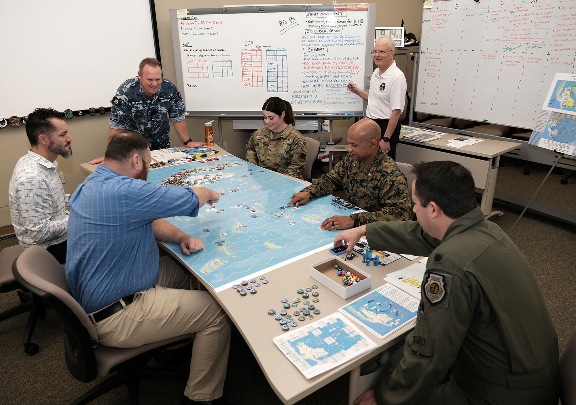 Uniformed US and Royal Australian Air Force members along with civilians test new Kingfish gameboard for Air Operations Center Initial Qualification Training Course