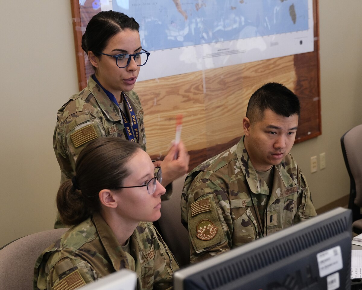 Uniformed US military personnel train at computers during the Air Operations Center Initial Qualification Training Course at Hurlburt Field, Florida.