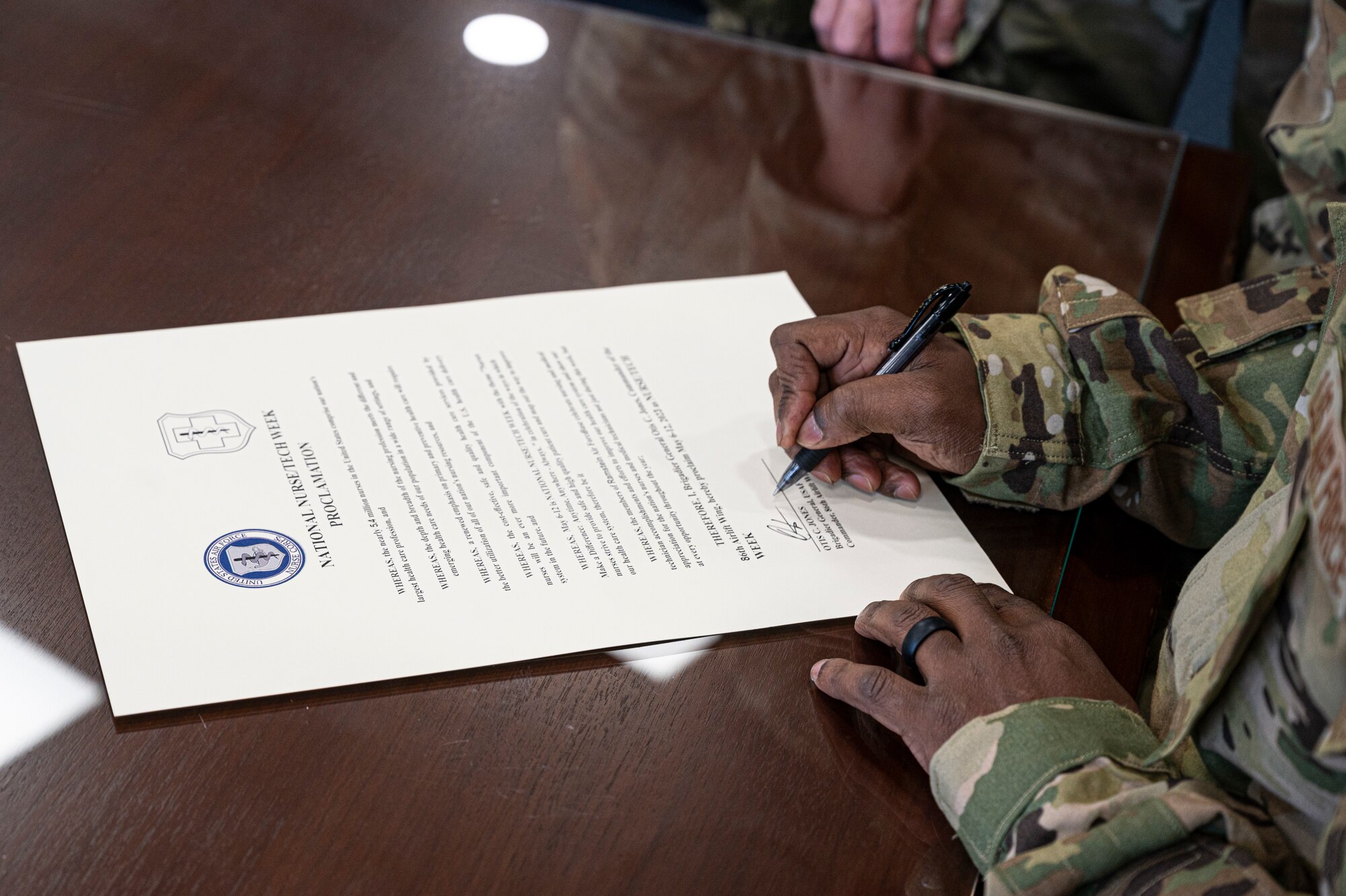 U.S. Air Force Brig. Gen. Otis Jones, 86th Airlift Wing commander signs a memorandum for Nurse Tech Week at Ramstein Air Base, May, 8, 2023. Nurse and Tech Week is seen in the U.S. Air Force as a way to show appreciation for the hard work and dedication displayed by nurses and medical technicians around the globe. (U.S. Air Force photo by Senior Airman Thomas Karol)