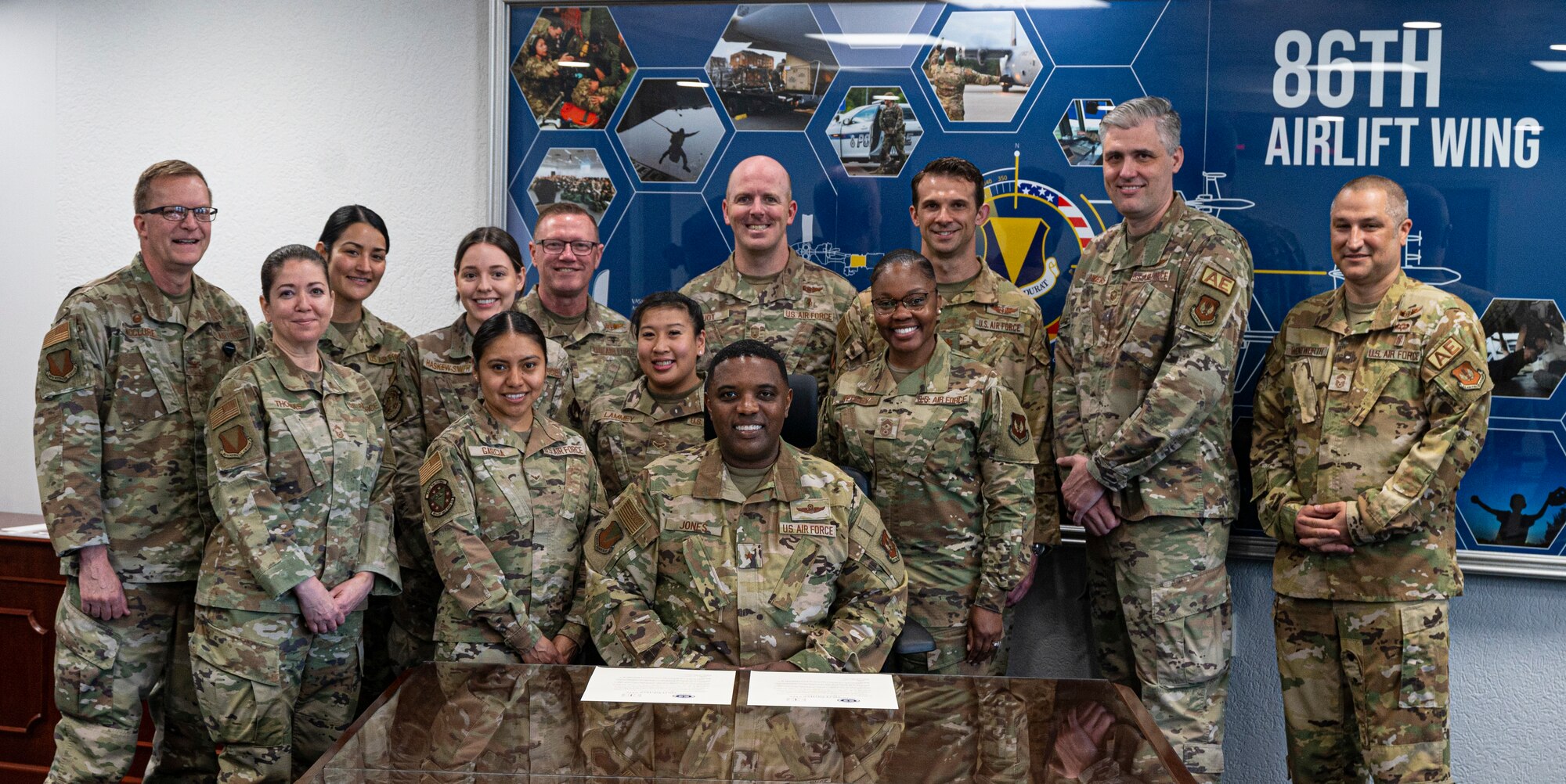 U.S. Air Force Brig. Gen. Otis Jones, 86th Airlift Wing commander, center, poses for a photo with members from the 86th Medical Group after signing the Nurse and Tech Week Memorandum at Ramstein Air Base, May, 8, 2023. Nurse and Tech Week was created in honor of Florence Nightingale, who was responsible for pioneering and standardizing nursing practices in the late 19th Century and many of the processes are still used today. (U.S. Air Force photo by Senior Airman Thomas Karol)