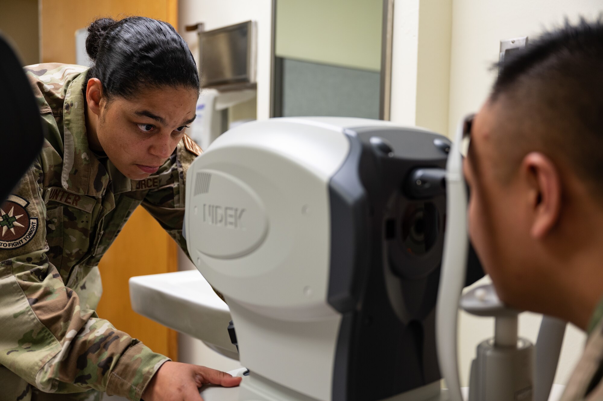 woman looks into a machine