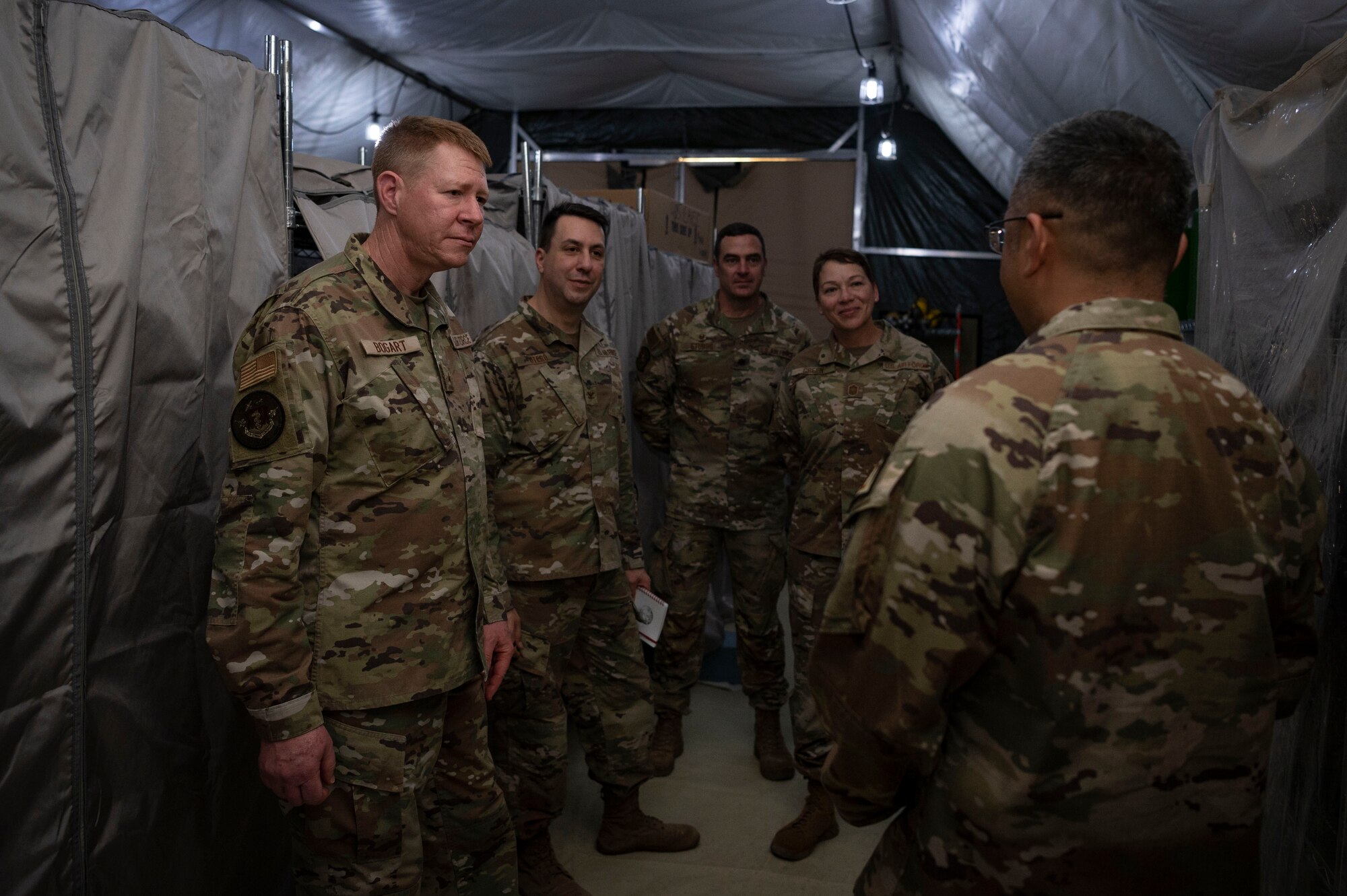 U.S. Air Force Brig. Gen. Robert Bogart, Headquarters Air Combat Command command surgeon, is briefed during a tour at Ali Al Salem Air Base, Kuwait, May 8, 2023.