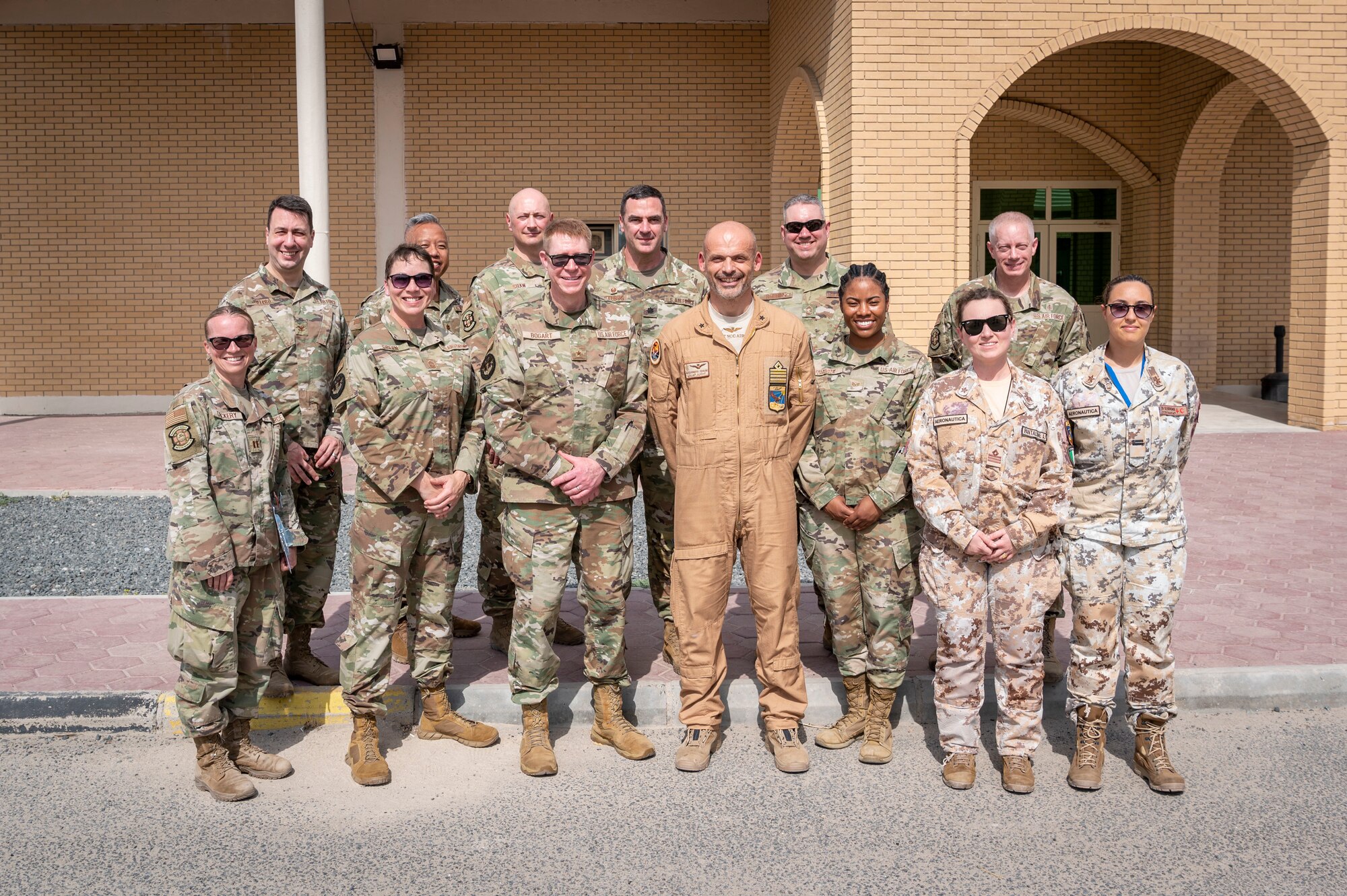 U.S. Air Force Brig. Gen. Robert Bogart, Headquarters Air Combat Command command surgeon, poses for a photo with U.S. and coalition partner personnel during a tour at Ali Al Salem Air Base, Kuwait, May 8, 2023.