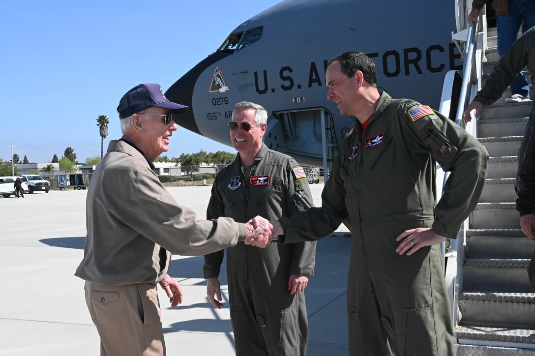 World War II veteran James K. Kunkle (left) shakes hands with Col. Andrew Malousek, 155th Air Refueling Wing vice commander, on the flight line of Central Coast Jet Center in Santa Maria, Calif., prior to the aircrew welcoming Kunkle aboard a Nebraska Air National Guard KC-135 Stratotanker for an orientation flight April 25, 2023.