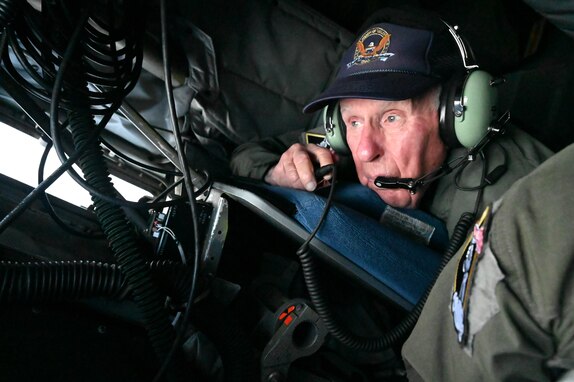 World War II veteran James K. Kunkle lays in the back of a KC-135 boom pod and watches the boom operator refuel an F15-C Eagle from the 114th Fighter Wing, Fresno, California, April 25, 2023. 