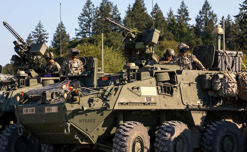 Soldiers from 3rd Platoon, Blackhorse Company, 2-3 Infantry Regiment, 1-2 Stryker Brigade Combat Team wear upgraded Integrated Visual Augmentation System goggles while sitting atop Stryker armored vehicles preparing for a movement-to-contact urban raid exercise on Joint Base Lewis-McChord, Wash., August 24, 2022. The exercise was part of a two-day demonstration event hosted by the Program Executive Office of Ground Combat Systems with the aim of integrating soldier feedback into the development of new military combat technology. (U.S. Army photo by Spc. Chandler Coats, 5th Mobile Public Affairs Detachment)