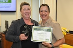 Ms. Renae Vessov, a registered nurse in Naval Medical Center Camp Lejeune's Neonatal Intensive Care Unit is presented the National Daisy Award by U.S. Navy Captain Alison Castro (right), Director for Nursing Services during an official ceremony on May, 9, 2023.