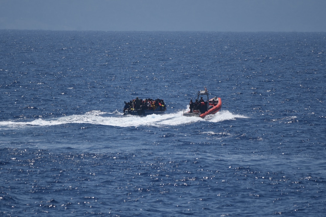 A USCGC Thetis (WMEC 910) boarding team approaches an overcrowded, homemade vessel with 31 Cuban migrants aboard, adrift in the Florida Straits, March 11, 2023. Thetis’ boarding team provided the passengers with lifejackets prior to embarking them onto the cutter’s small boat and transferring them to Thetis. (U.S. Coast Guard photo by Petty Officer 2nd Class William Slade)