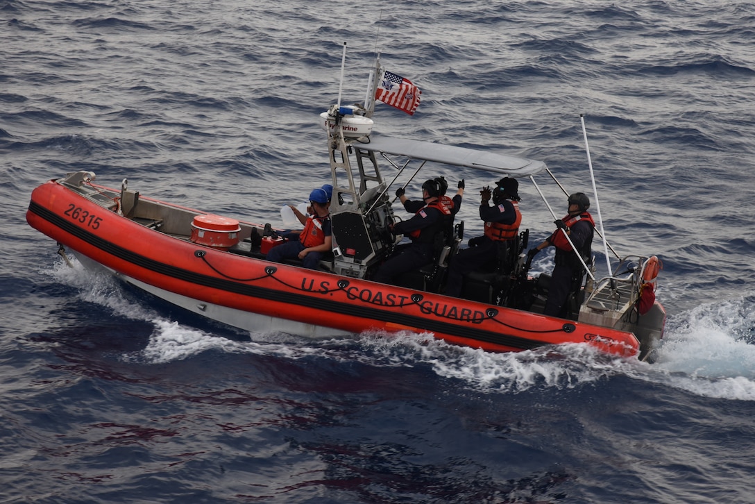 A USCGC Thetis (WMEC 910) boarding team departs via small boat with CG-P6 dewatering pumps and jugs of drinking water to provide rescue assistance to a Haitian sailing vessel taking on water off the coast of Ile de la Tortue, Haiti, March 14, 2023. While patrolling off the coast of Haiti, Thetis watch standers spotted sailors aboard a Haitian sailboat waving their arms indicating distress. (U.S. Coast Guard photo by Petty Officer 3rd Class Elijah De La Torre)