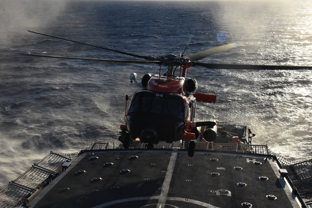 A U.S. Coast Guard Air Station Clearwater MH-60 helicopter crew forward-deployed to Operation Bahamas and Turks and Caicos in Inagua, Bahamas, conducts a series of day and night landings, March 24, 2023, aboard the USCGC Thetis (WMEC 910) flight deck. Thetis' crew returned to their home port in Key West, Thursday, following a 66-day patrol in the Florida Straits and Caribbean Sea. (U.S. Coast Guard photo by Petty Officer 3rd Class Bethany Squires)