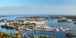 An aerial view of Portsmouth Naval Shipyard on an island in the middle of a small bay.